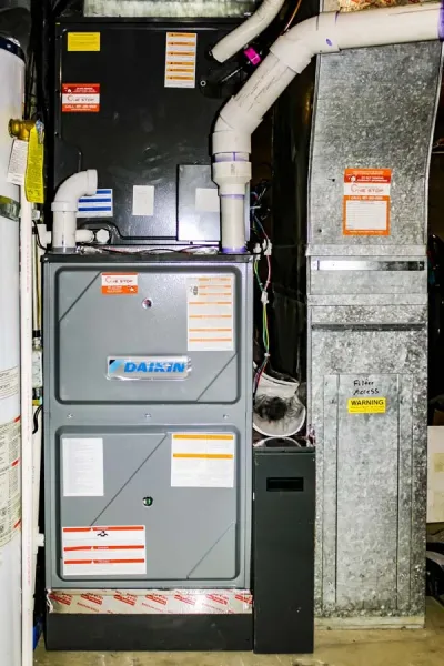 A Daikin brand furnace system installed in a residential basement, with various pipes and ventilation components connected in Salt Lake City, UT