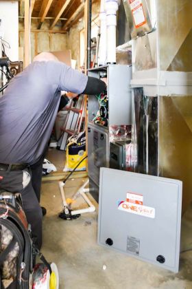 A Technician working on furnace Maintenance in Riverton, UT