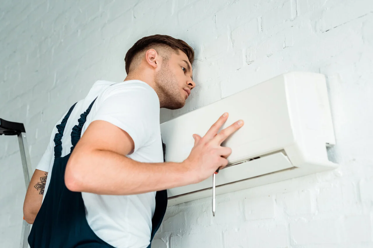 Worker Installing Air Conditioner in 11